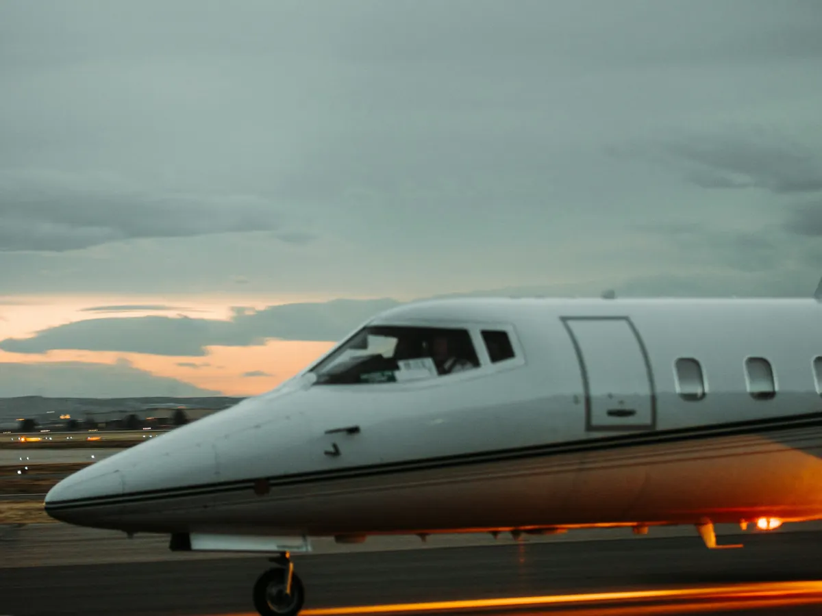 Nose of a business jet on a ramp at dusk