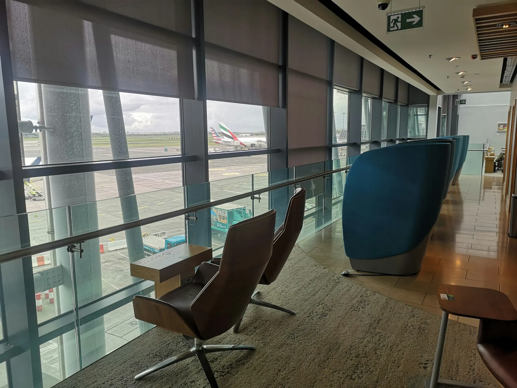Private terminal lounge with armchairs facing the airfield